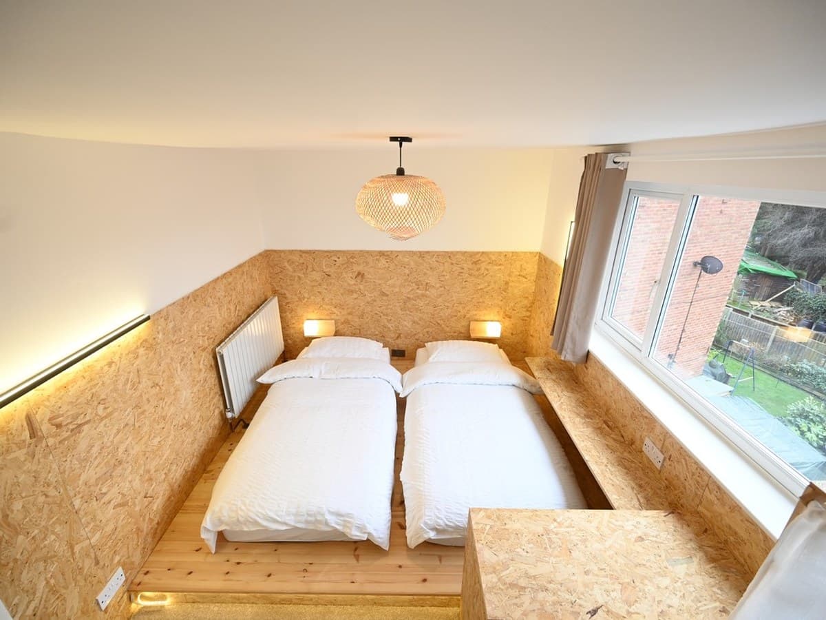 The twin room at night, lit from behind the headboard